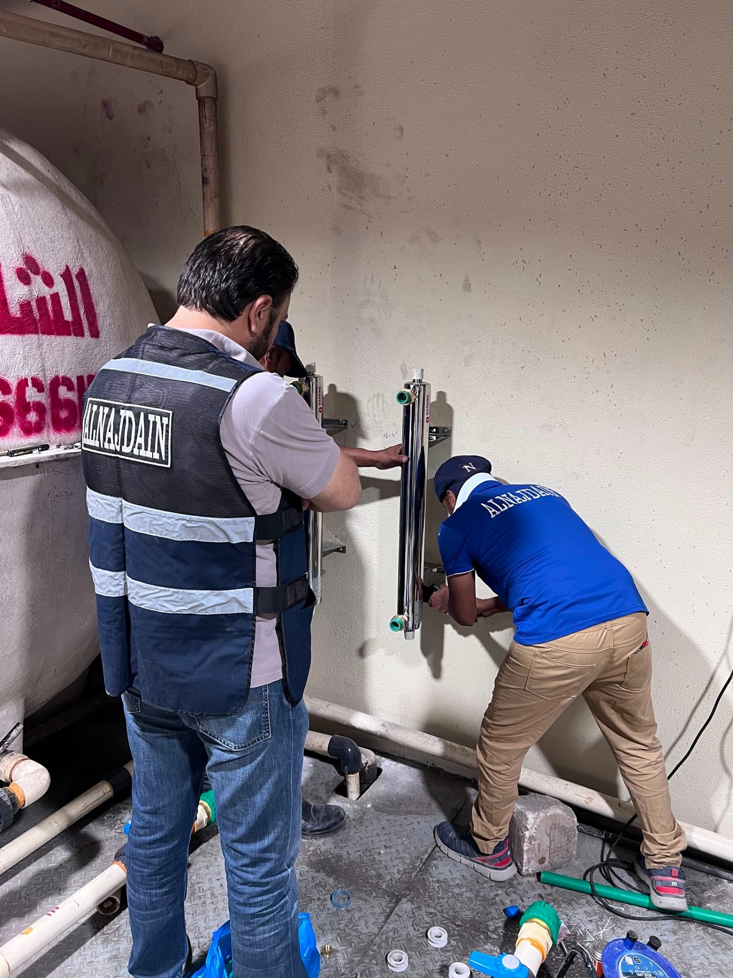Alnajdain team installing UV sterilizers on site